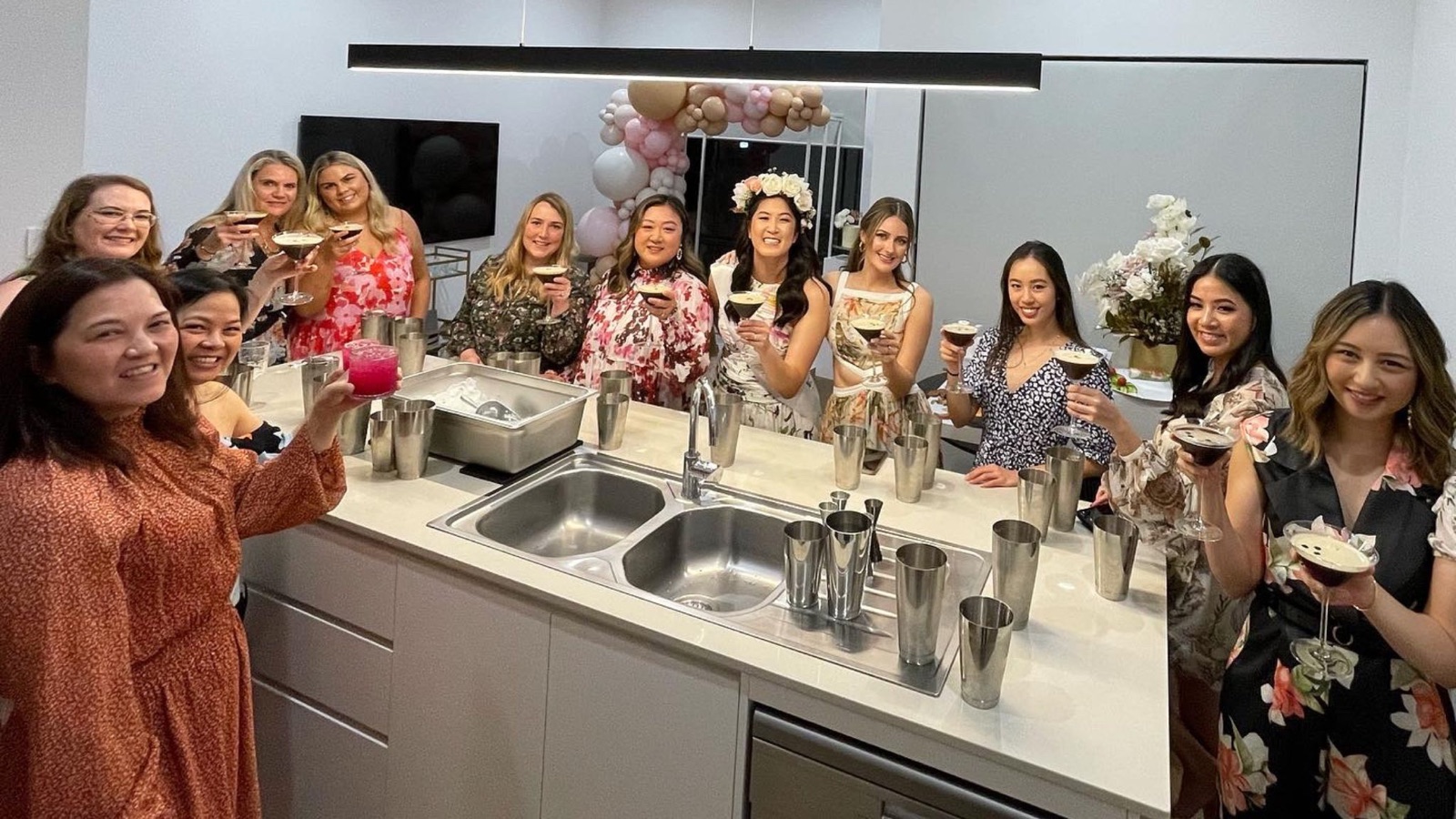A hens party raising the cocktails they made during a class in a Perth home